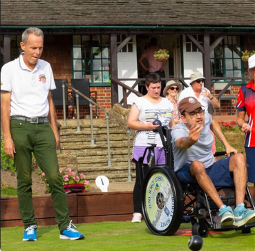 Addlestone high street with local businesses and families